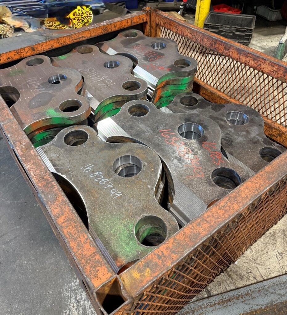 Fabricated metal parts in industrial crate
